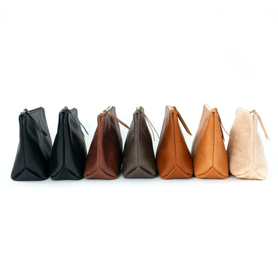 Handmade leather makeup bags in several colors.  Handmade with vegetable tanned leather and monogrammed.