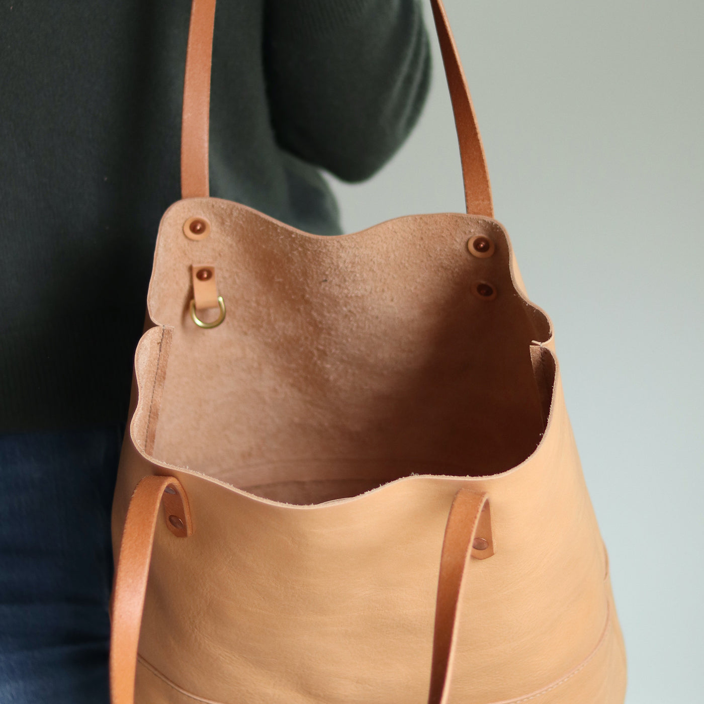Minimalist beige leather tote with interior slip pocket and D-ring for keys, made in Vermont.