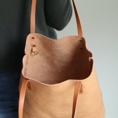 Minimalist beige leather tote with interior slip pocket and D-ring for keys, made in Vermont.