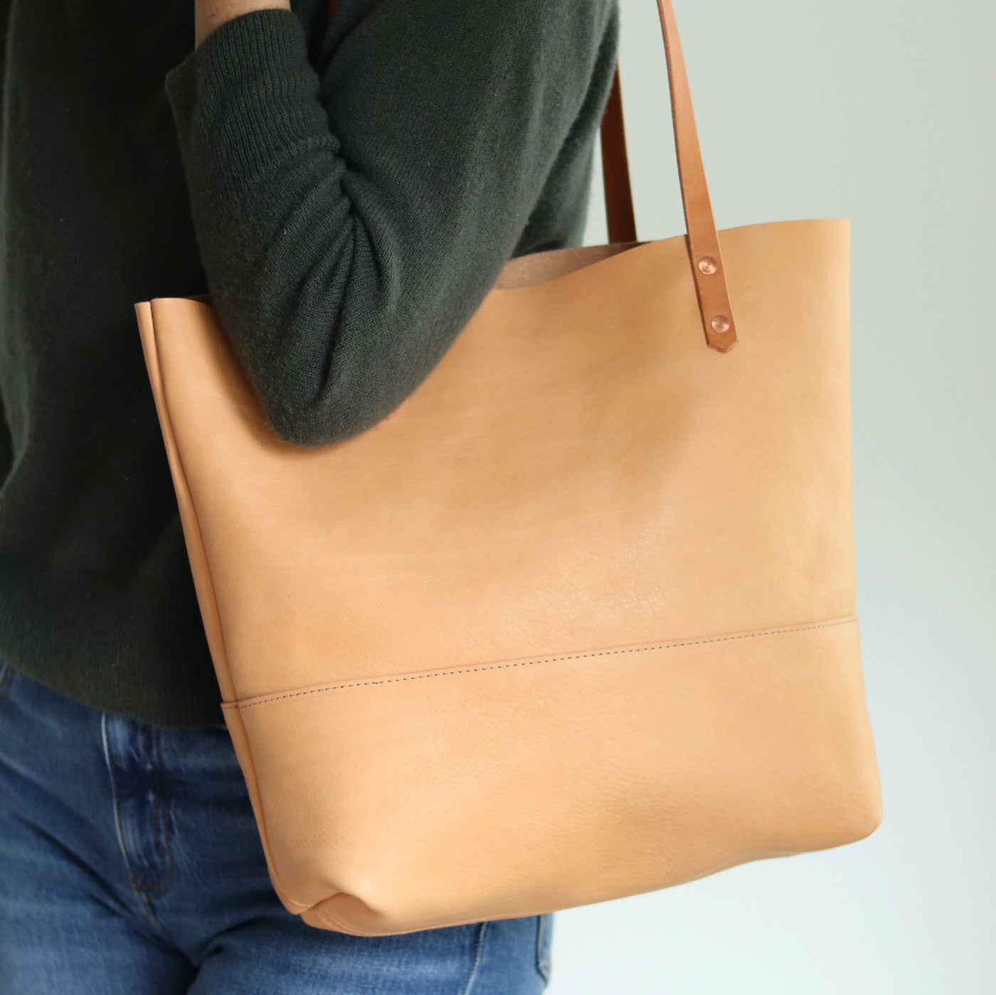 Full-grain vegetable-tanned leather tote in beige, fits a 13-inch laptop, handcrafted artisan bag.