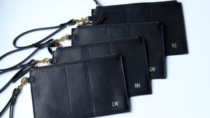 Personalized black leather zipper clutches with gold foil monogram and wrist strap, handmade with vegetable tanned leather, bridesmaid gift clutch set