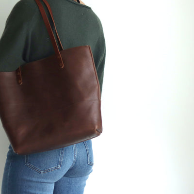 woman wearing classic brown italian leather tote bag handmade with full grain italian vegetable tanned leather