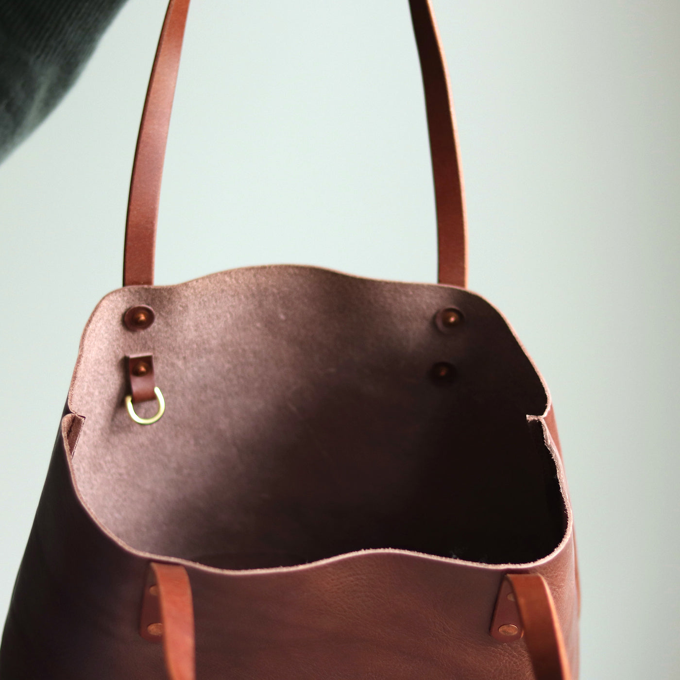 Interior of Italian leather tote with slip pocket and D-ring for keys.