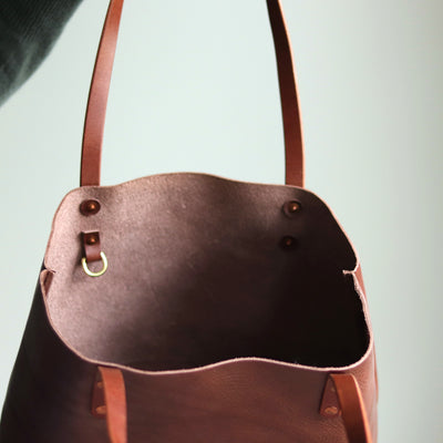 Interior of Italian leather tote with slip pocket and D-ring for keys.