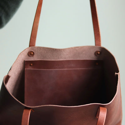 Interior of Italian leather tote with slip pocket and D-ring for keys.