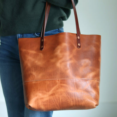 Close-up of natural leather texture and dramatic pull-up on Horween leather tote bag.