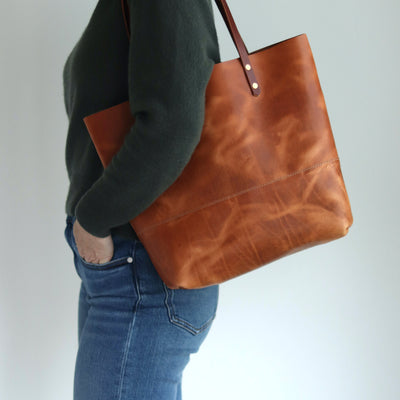 Distressed brown Horween leather tote bag with unique pull-up and copper rivet details, handcrafted in Vermont.