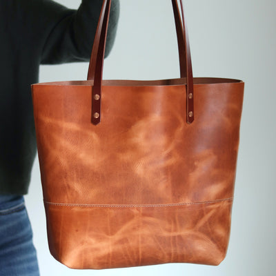 Artisan-made Horween leather tote with full-grain texture and unique patina.