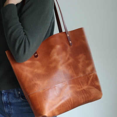 Distressed brown Horween leather tote bag with unique pull-up and copper rivet details, handcrafted in Vermont.