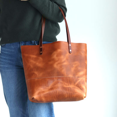 Distressed brown Horween leather tote bag with pull-up and copper rivet details, handcrafted in Vermont. Vegetable tanned leather minimalist tote