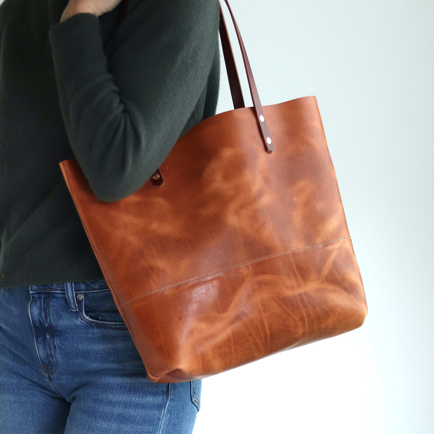 Minimalist Distressed brown Horween leather tote bag with unique pull-up and copper rivet details, handcrafted in Vermont.