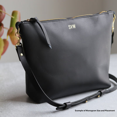 Black leather simple crossbody bag with gold foil monogram, top zipper, and adjustable black leather strap.  Handmade by Juliette Rose Designs.