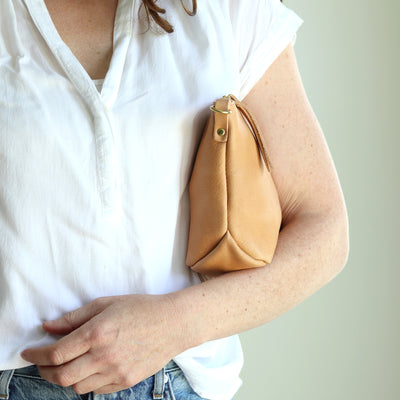 Small soft beige undyed leather convertible clutch purse with removable strap and top zipper.  Handmade with vegetable tanned leather by Juliette Rose Designs