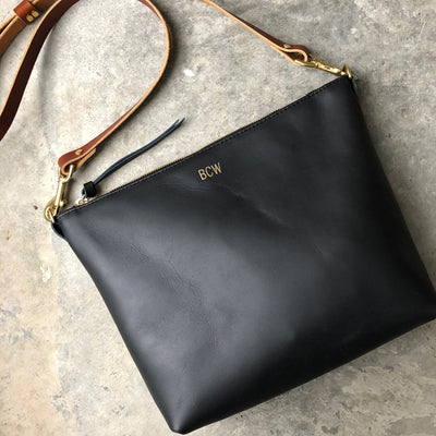 Simple black leather women's crossbody bag with brown adjustable strap and gold foil monogram by Juliette Rose Designs