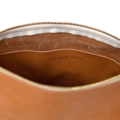 Interior slip pocket of Juliette Rose Designs handmade leather bag in beige color, handmade with vegetable tanned leather and with a top zipper closure.